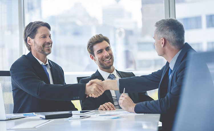 Business men making a deal at a meeting