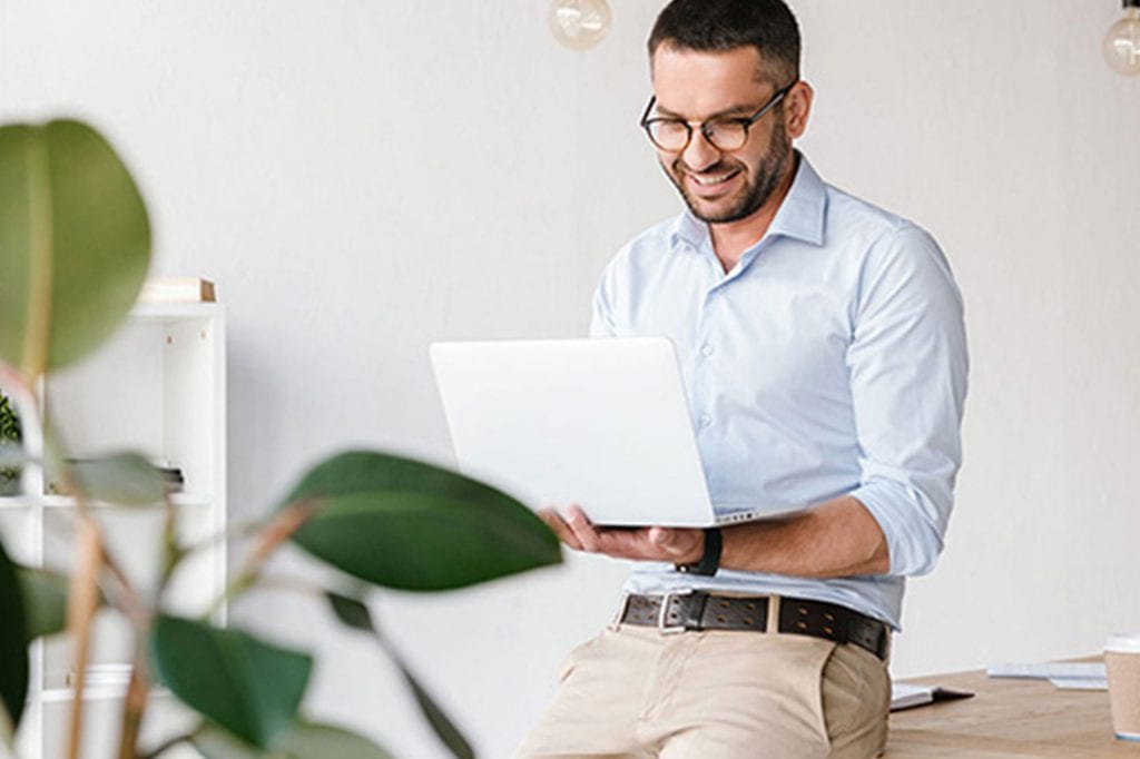 man writing a cover letter on his laptop