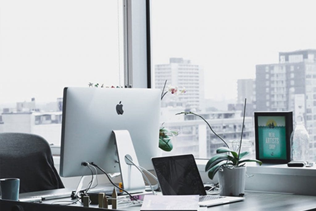 Office with glass walls overlooking a city